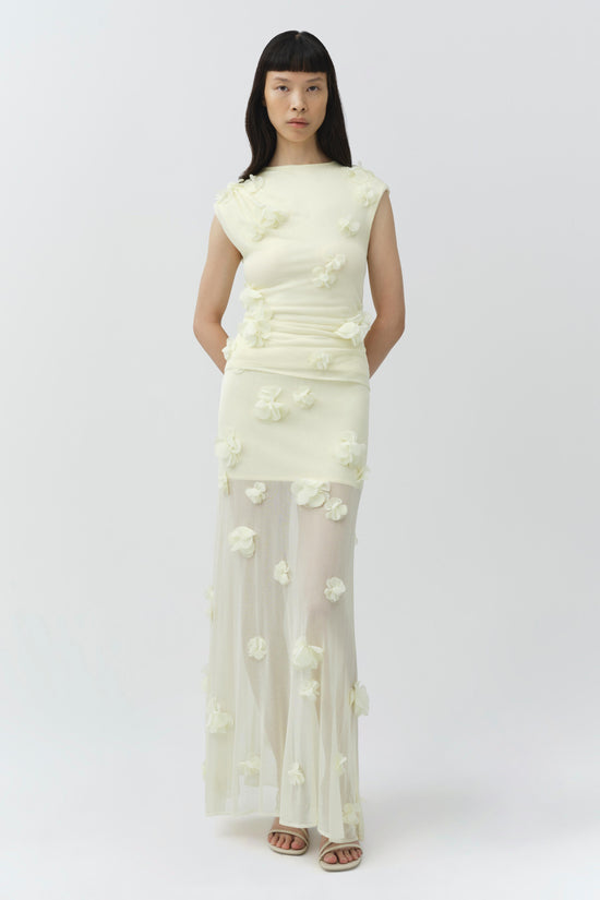 Cream midi skirt with white floral appliqués, sheer mesh lower section, worn with matching sleeveless top.