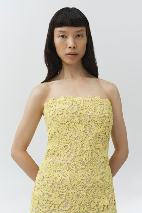 Yellow lace strapless bustier dress with all-over floral pattern and visible side seams.
