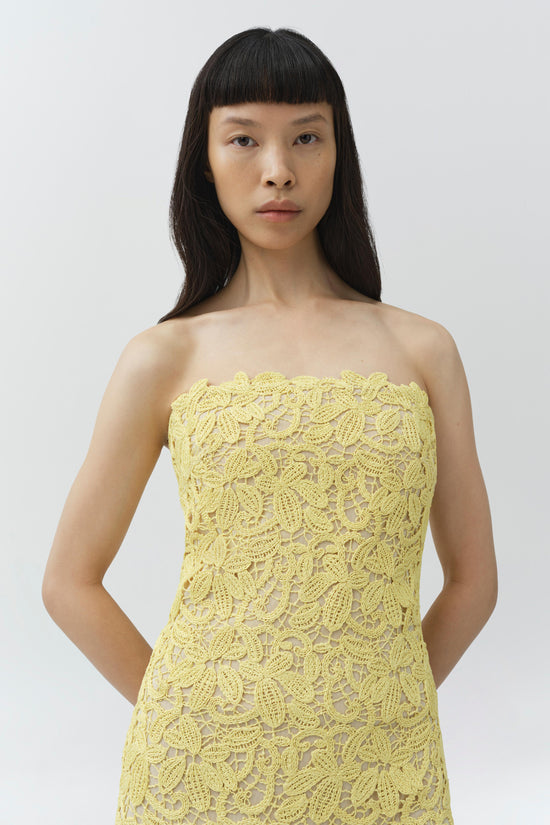 Yellow lace strapless bustier dress with all-over floral pattern and visible side seams.