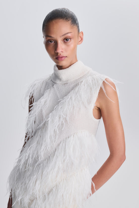 White sleeveless top with turtleneck collar and diagonal feather detailing across the front.