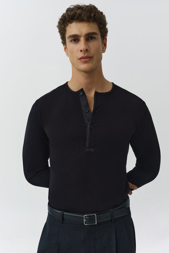 Black ribbed henley with button placket and long sleeves on male model.