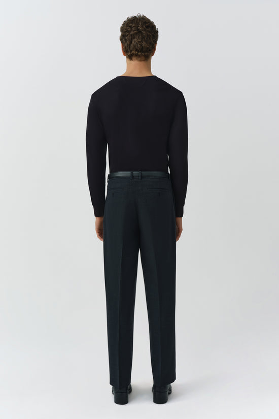 Black ribbed long-sleeve henley with crew neckline, shown from back on model wearing dark trousers.