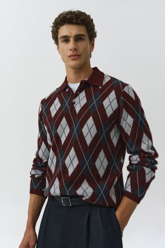 Burgundy and gray argyle polo with white undershirt and navy trousers, displayed on a model.