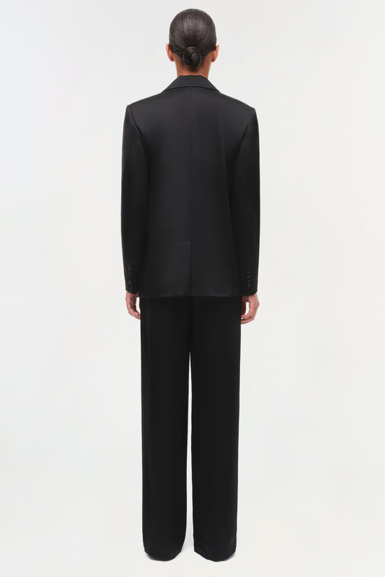 Person wearing a black suit viewing from the back