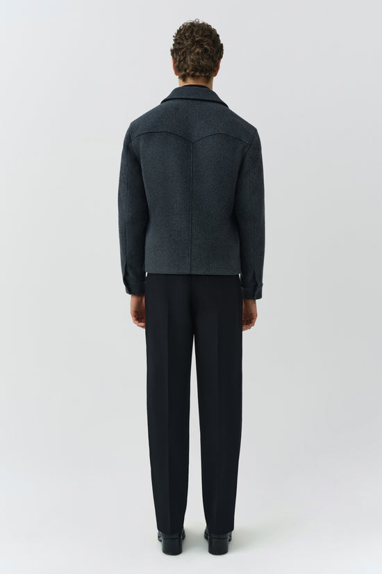 Man wearing dark gray wool jacket with collar, shown from behind, paired with black trousers.