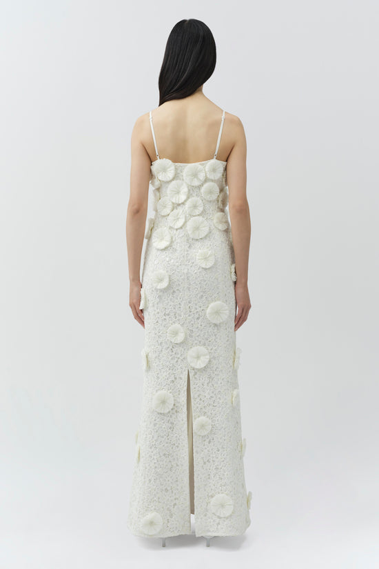 White lace floor-length gown with cream raffia floral appliqués and thin spaghetti straps, shown from back view.