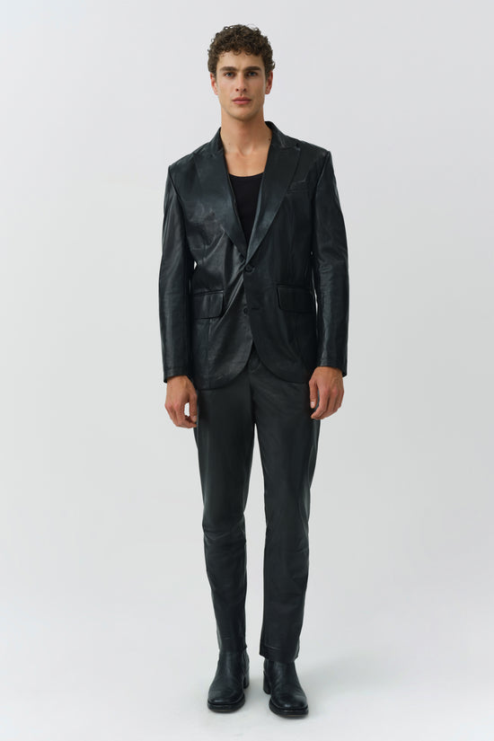 Black leather blazer with notch lapels, button front, and chest pocket worn with matching black trousers.