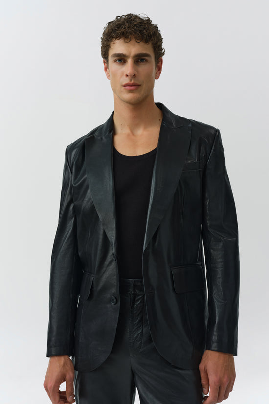 Black leather blazer with notch lapels, worn open over a black ribbed t-shirt.