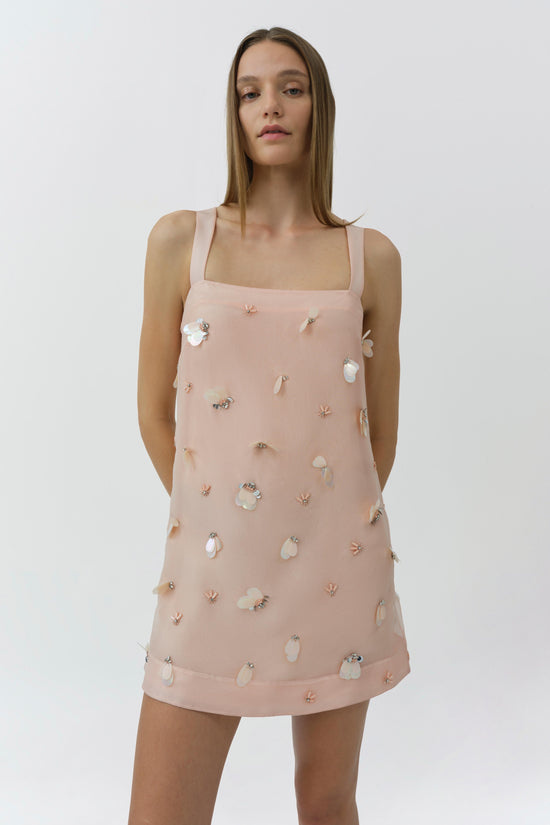 Blush pink sleeveless mini dress with square neckline and scattered crystal and pearl embellishments throughout.