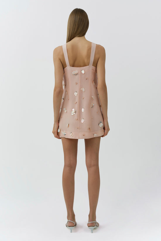 Blush pink sleeveless mini dress with scattered pearl and crystal embellishments, shown from back view.