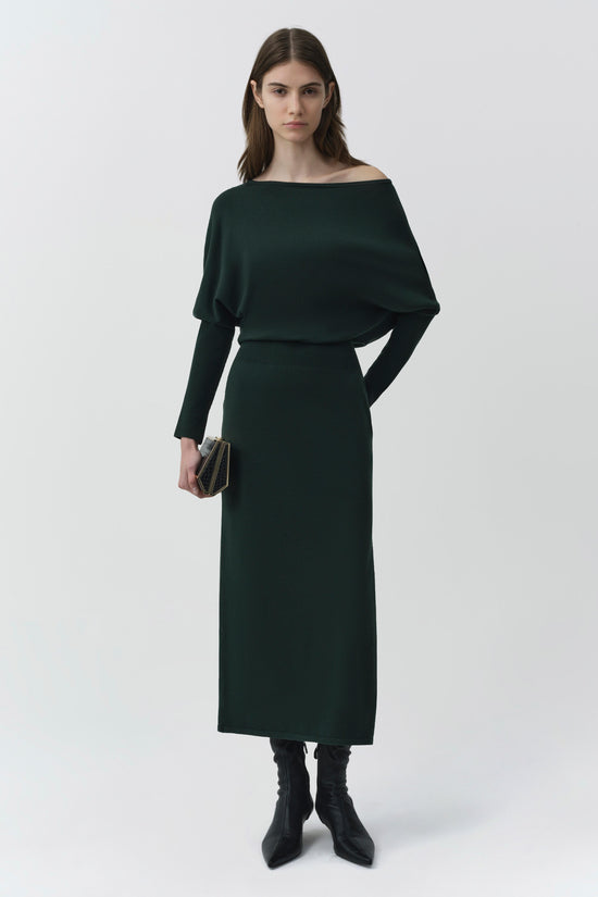 Black off-shoulder knit midi dress with long sleeves and fitted waist, paired with black boots.