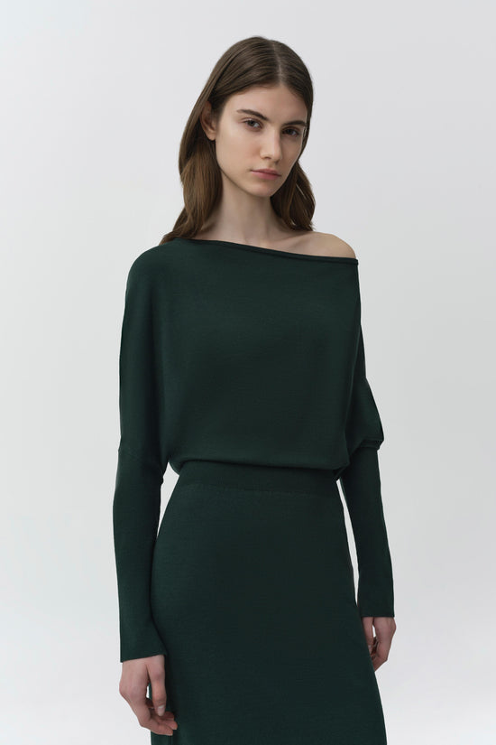 Dark green knit midi dress with off-shoulder neckline and long sleeves on model.