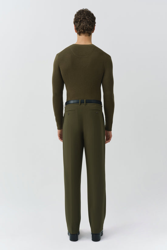 Man wearing olive green ribbed henley with long sleeves and matching trousers, shown from back.