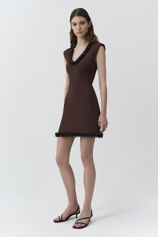 Brown sleeveless knit mini dress with black beaded neckline and hem trim.