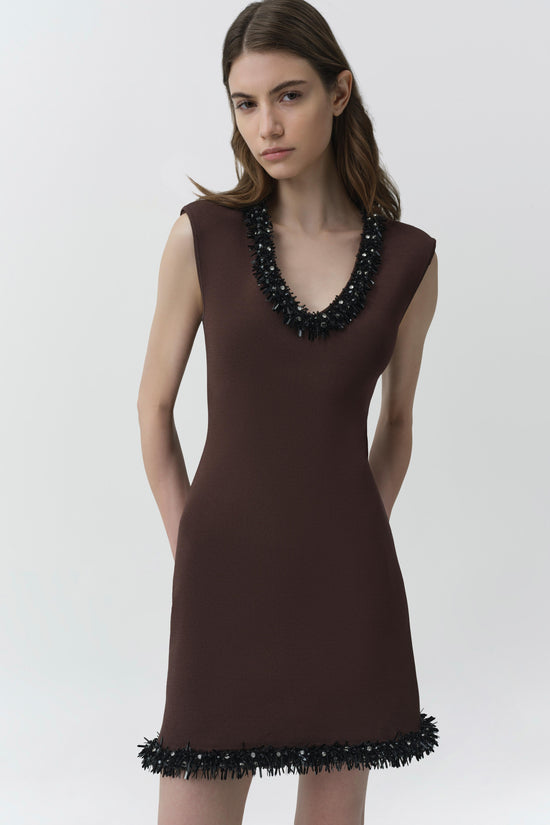 Brown sleeveless knit mini dress with V-neckline and black beaded trim at neckline and hem.