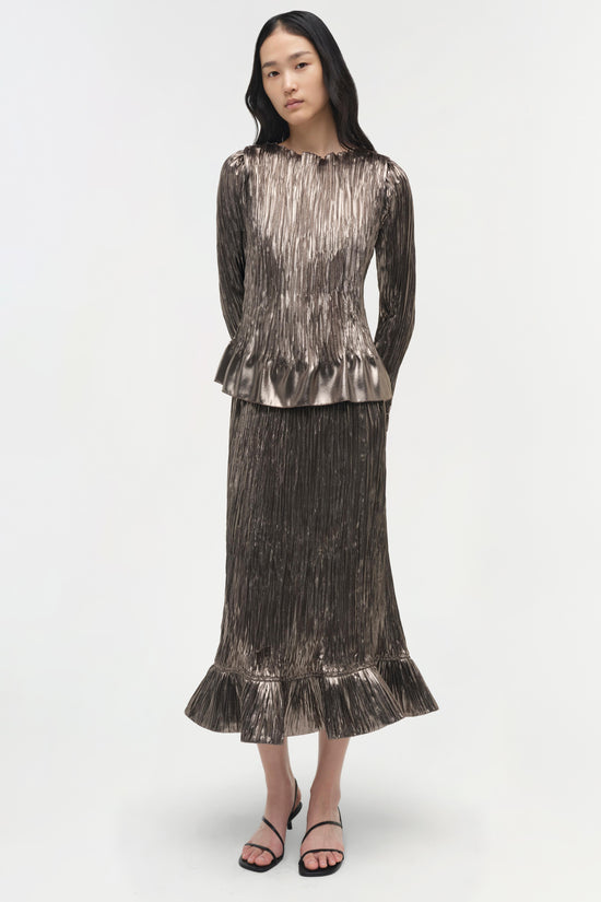 Silver metallic pleated top with long sleeves, crew neckline, and gathered ruffle hem at waist.