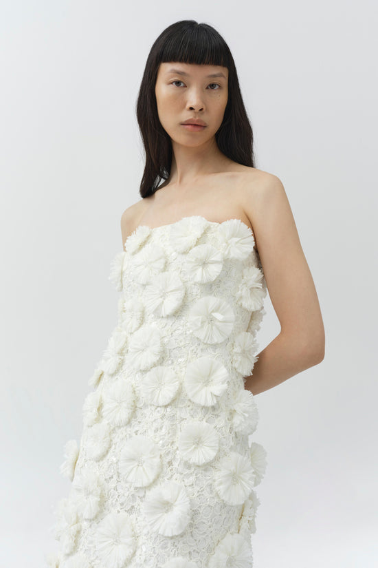 Ivory strapless mini dress with textured floral raffia appliqué and lace detailing throughout.