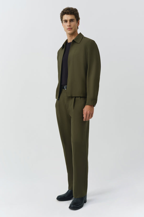 Man wearing olive green Sidney Jacket with matching trousers and black shirt underneath.