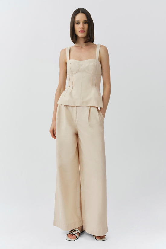 Beige cotton faille bustier top with square neckline and structured bodice on model wearing matching wide-leg pants.