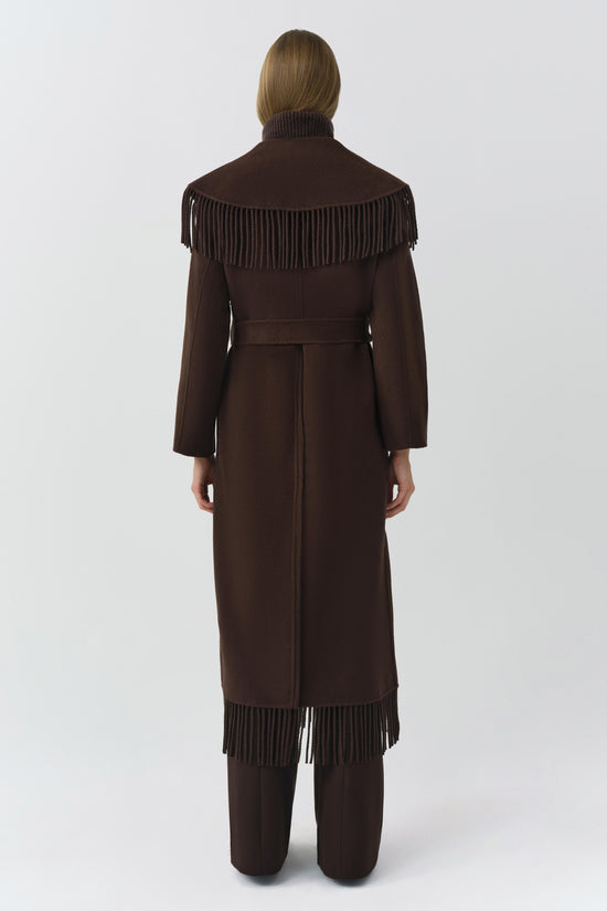 Brown wool coat with fringe trim on shoulders and hem, belted waist, long sleeves, modeled from back view.