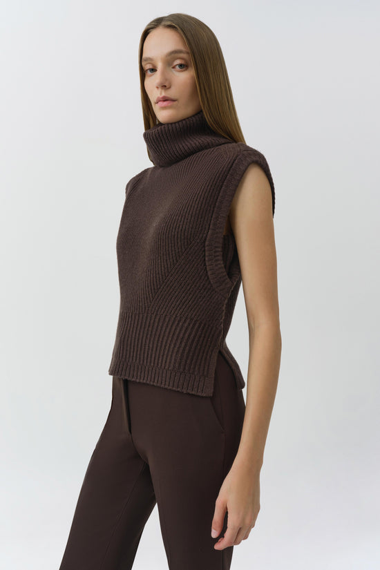 Brown ribbed sleeveless turtleneck knit top with fitted silhouette.