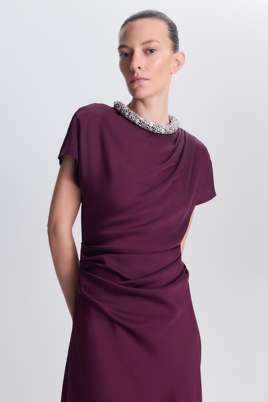 Burgundy satin gown with short sleeves, embellished neckline, and ruched waist detail.