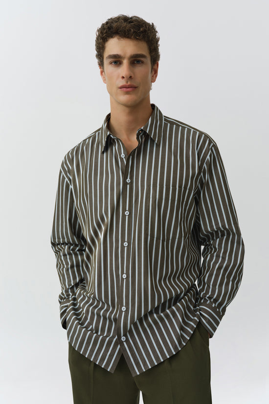 Oversized button-up shirt with black and white vertical stripes and long sleeves.