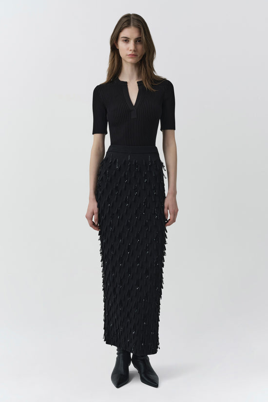 Black knit midi skirt with beaded embellishments and fringe detailing throughout.