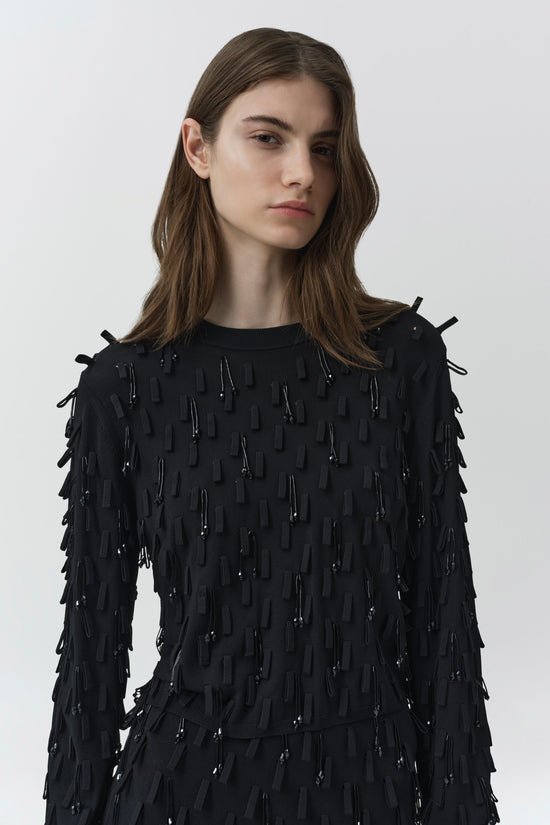 Black knit top with beaded fringe embellishment covering the front, sleeves, and shoulders.