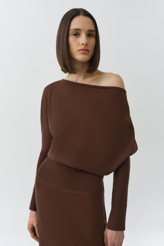 Brown off-shoulder dress with draped overlay and fitted ribbed waist.