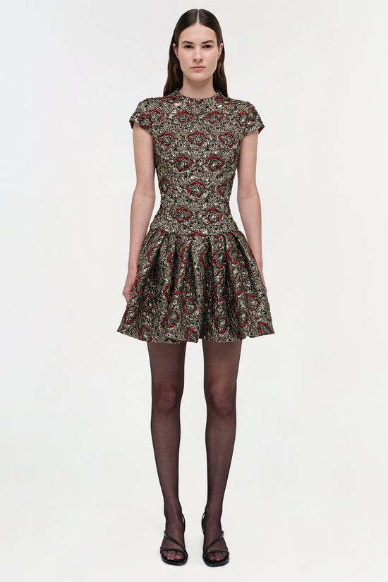 Short-sleeved mini dress with red and gold floral jacquard pattern, fitted bodice, and pleated skirt.