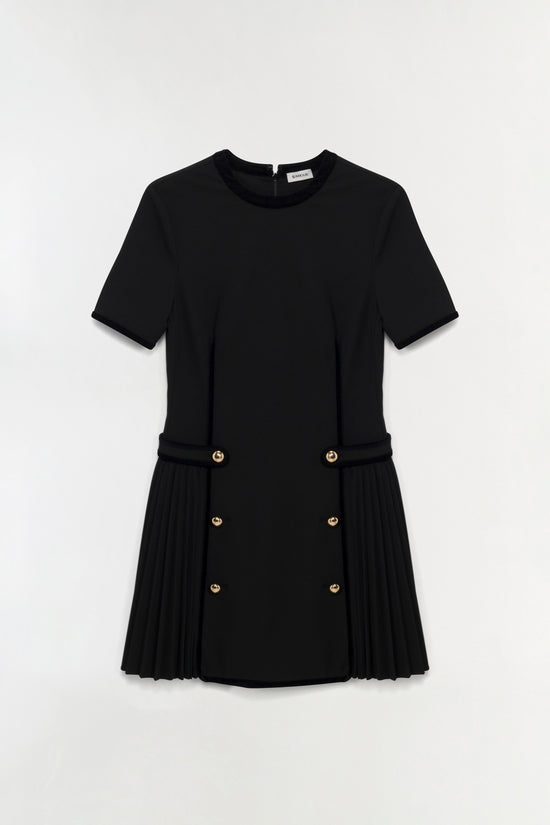 Black mini dress with short sleeves, gold button details, and pleated velvet-trimmed skirt panel.