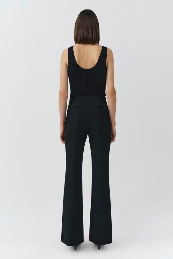 Black sleeveless tank top and flared pants worn by model, shown from back view.