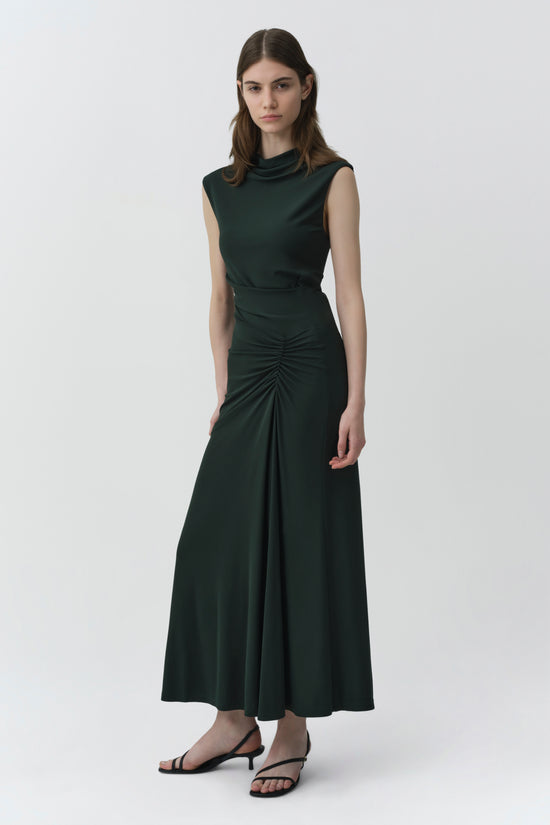 Dark green sleeveless midi dress with cowl neckline and ruched waist detail, modeled on a woman.