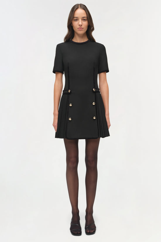 Black mini dress with short sleeves, gold button details, and pleated velvet trim skirt.
