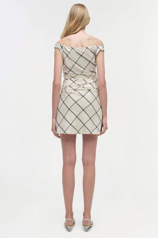 Beige mini dress with diagonal grid pattern and off-shoulder neckline, shown from back on model.