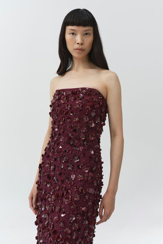 Burgundy strapless gown with sequin and beaded embellishments covering the bodice and skirt.