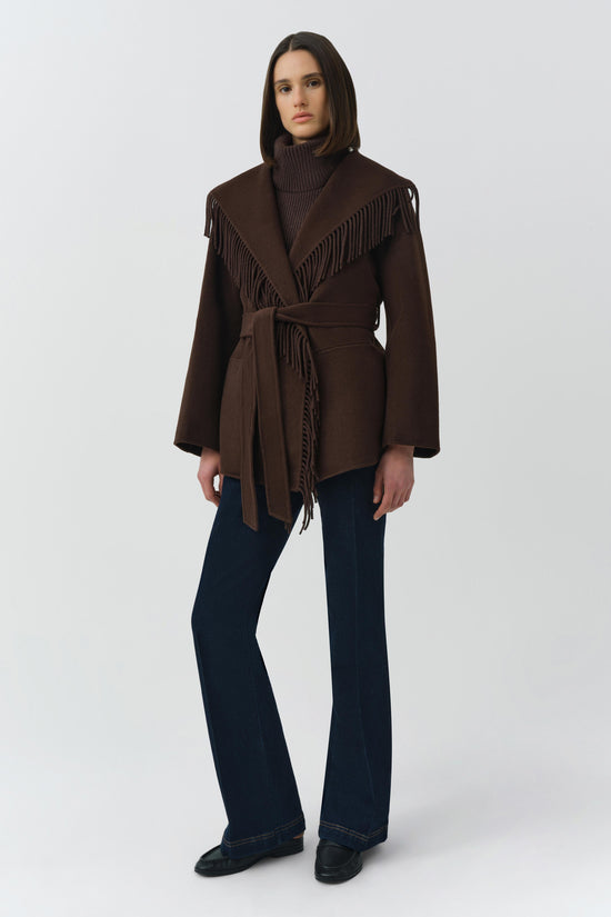 Brown wool jacket with fringe trim on shoulders and front, wide lapels, and tie belt at waist.