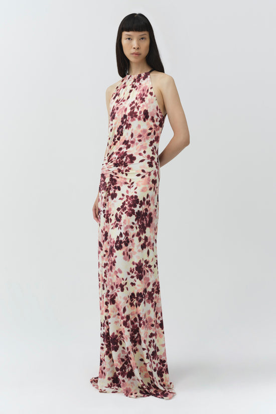 Sleeveless halter maxi dress in cream with burgundy and pink floral print, featuring draped fabric at the waist.