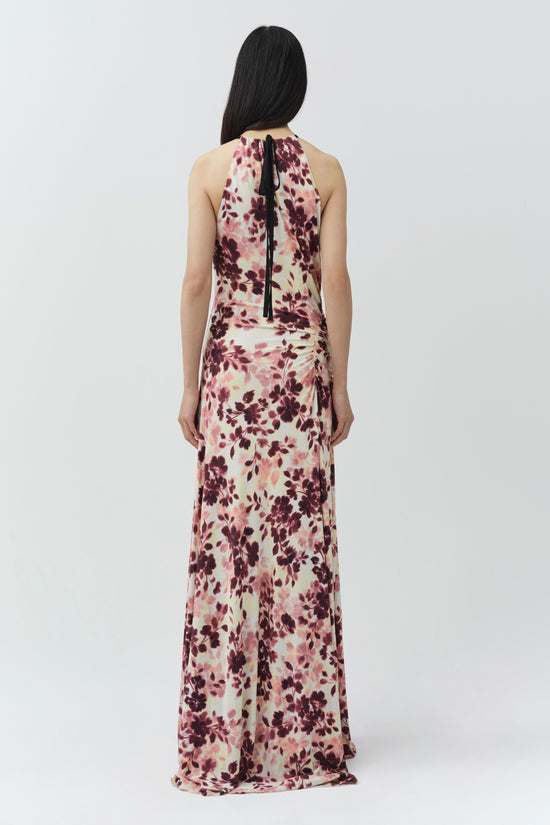 Cream maxi dress with burgundy and pink floral print, halter neckline, and draped ruching at waist, shown from back.