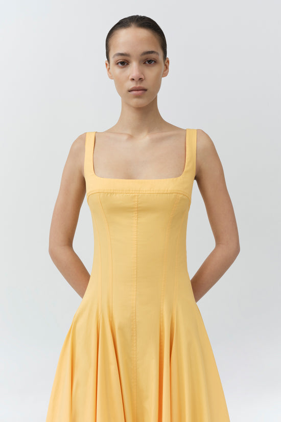 Yellow cotton midi dress with square neckline, sleeveless design, and A-line silhouette.