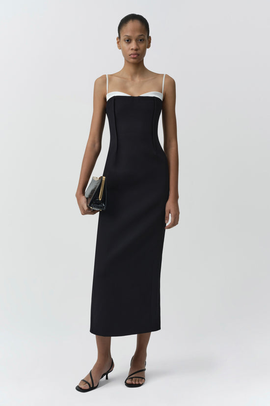 Black midi dress with white trim neckline, thin straps, and fitted silhouette.