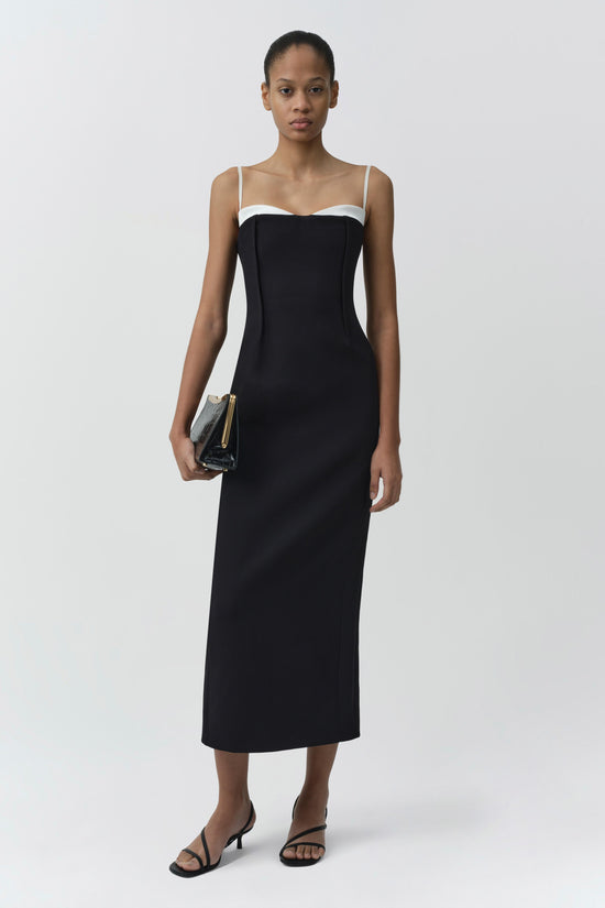 Black midi dress with white trim neckline, thin straps, and fitted silhouette.