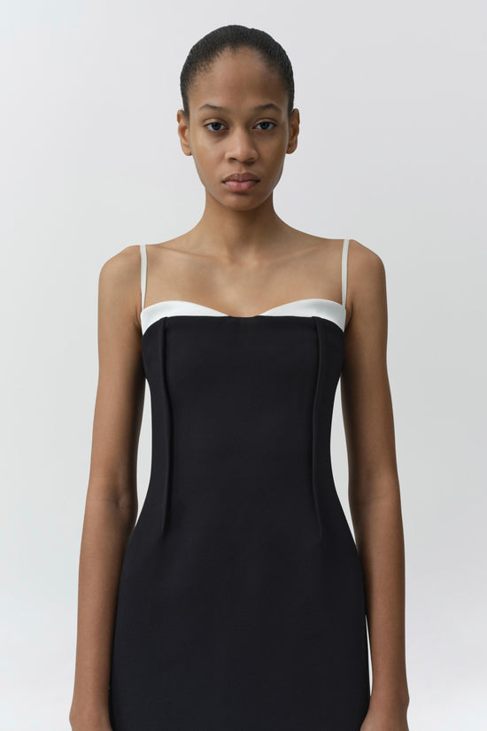 Black midi dress with white contrast neckline and thin shoulder straps.