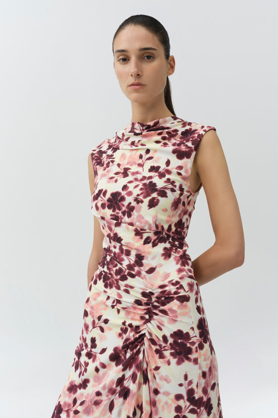 Sleeveless midi dress with burgundy and pink floral print on cream background, featuring draped ruching at waist and side.