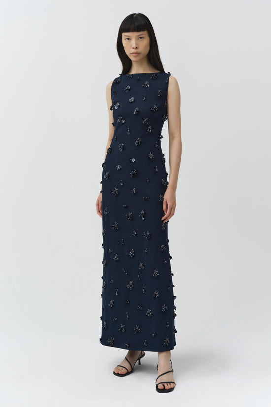 Navy sleeveless midi dress with scattered beaded embellishments throughout, worn with black platform sandals.
