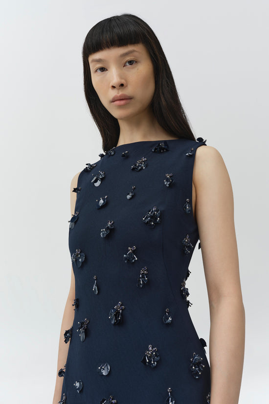 Navy sleeveless midi dress with scattered black beaded and sequin embellishments throughout.