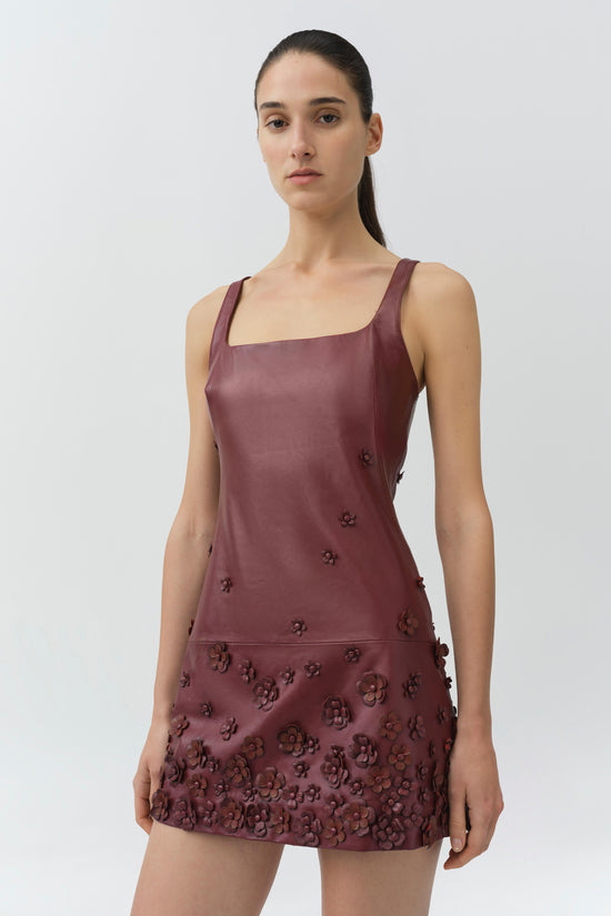 Burgundy leather mini dress with square neckline and dimensional floral appliqués covering the bodice and skirt.