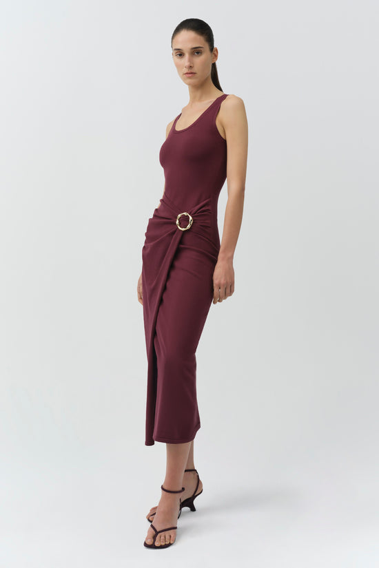 Burgundy sleeveless knit midi dress with draped ruching at waist and circular buckle detail.