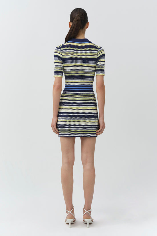 Knit mini dress with navy, yellow, and cream horizontal stripes and short sleeves, shown on model from back.